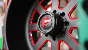 A close up of a black and red wheel.