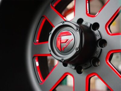A close up of a black and red wheel.